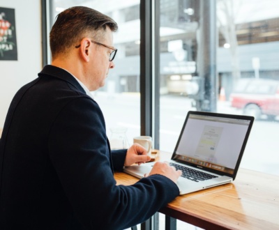 man wearing blue suit in front of MacBook Pro